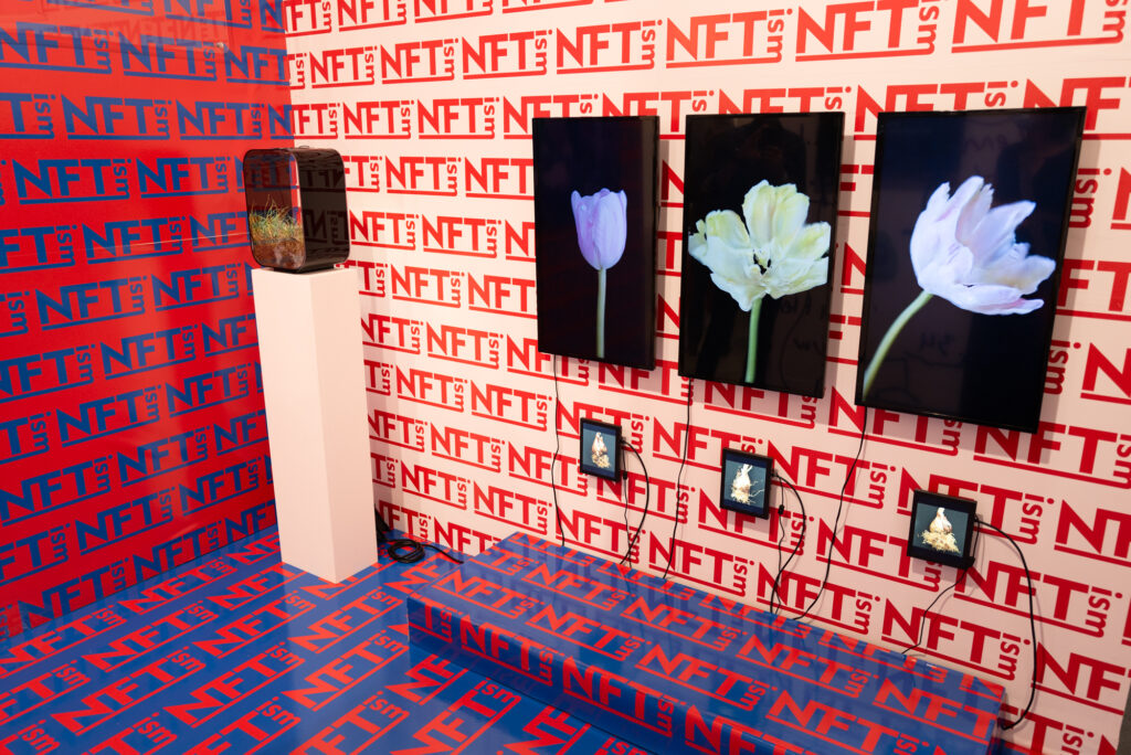 NFTism exhibition Art Basel 2021 digital art NFT displays floral artworks repeated NFT branding